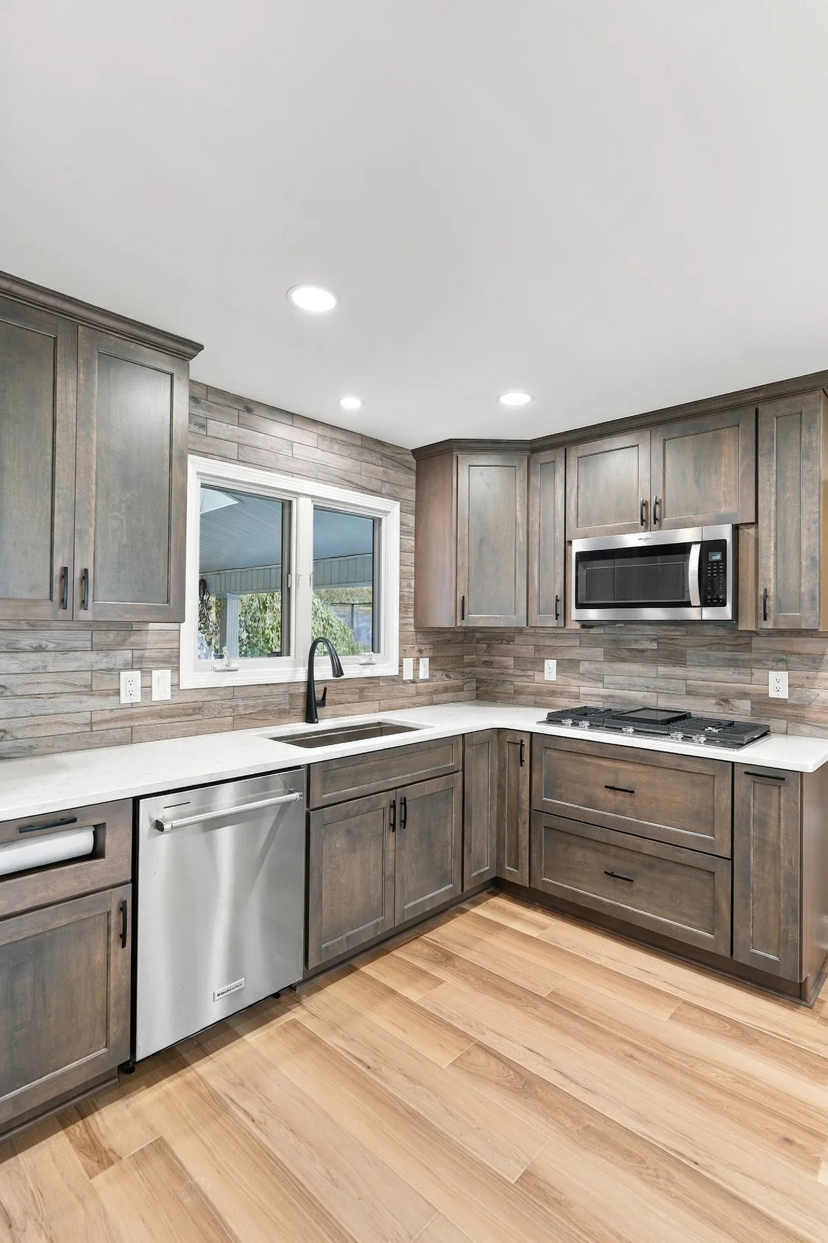 Patterned backsplash meeting the countertop at the kitchen sink and cooktop corner