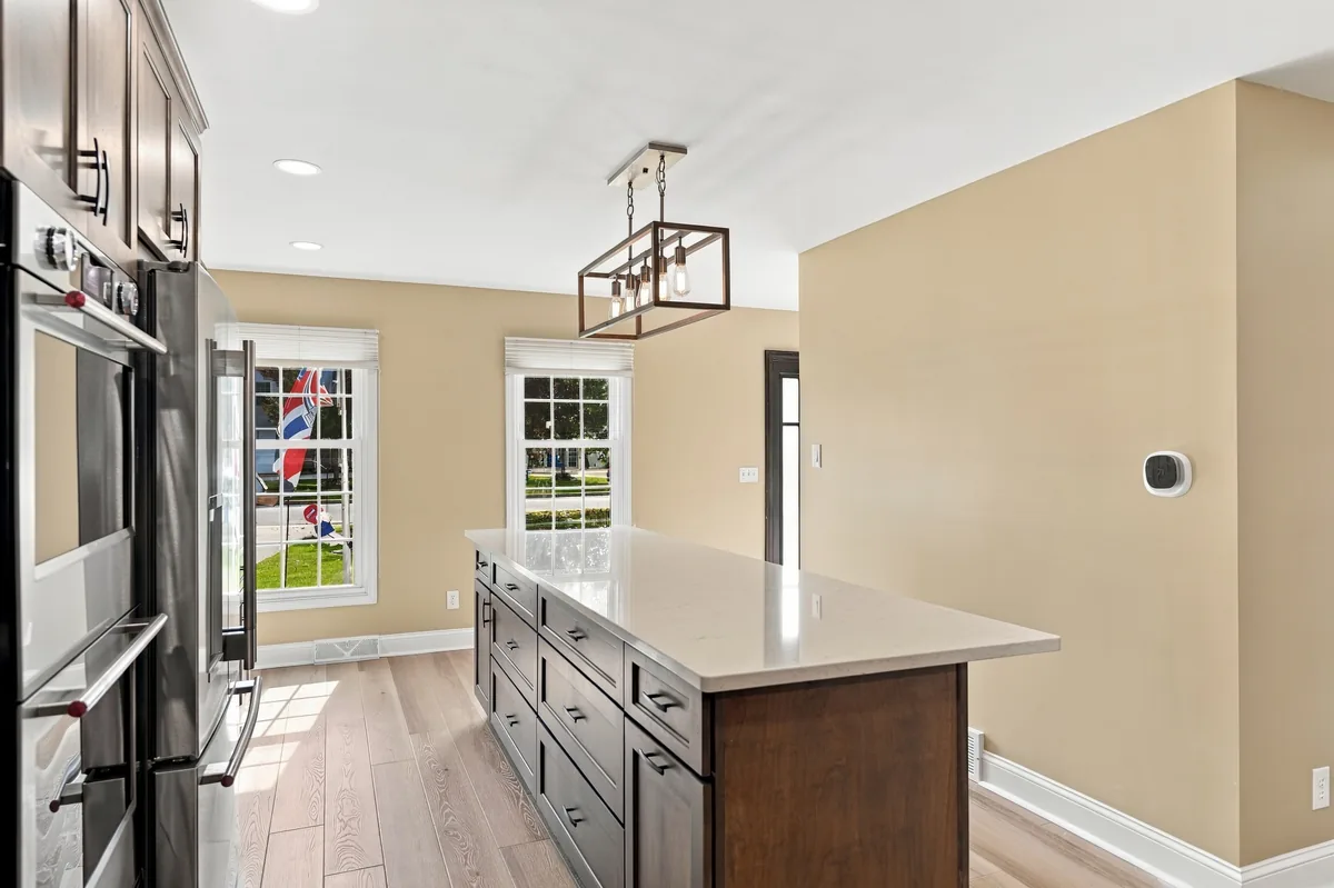 Wood-tone island drawers with kitchen windows in the background