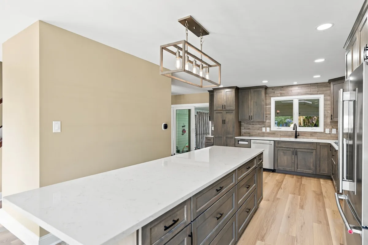 Drawers along the kitchen island and the walkway toward the sink